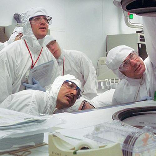 		Researchers examining new equipment.
	