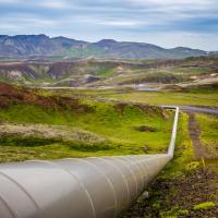 		above-ground pipeline extends across a rugged landscape
	