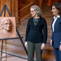 		Two people look at a piece of art portraying the face of Ruth Bader Ginsburg
	