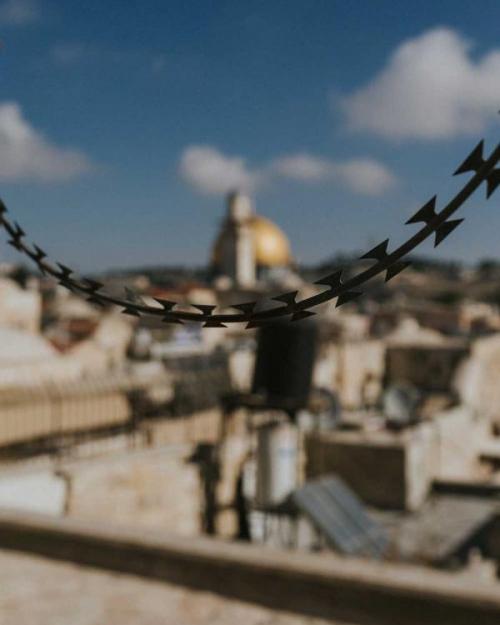 Wire up close; mosque in background