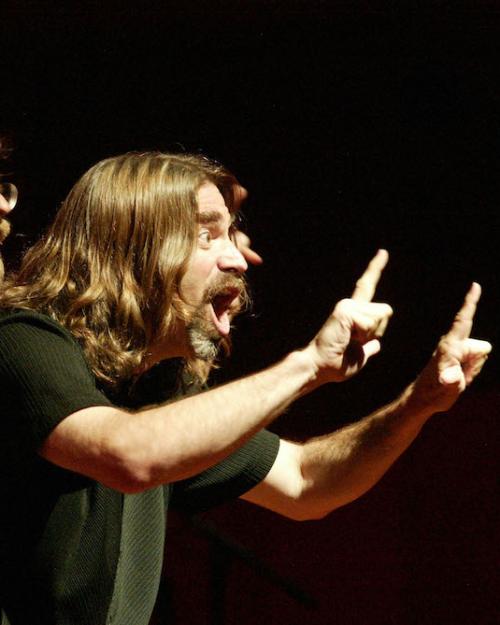 		Two people performing with dramatic hand gestures and facial expressions
	
