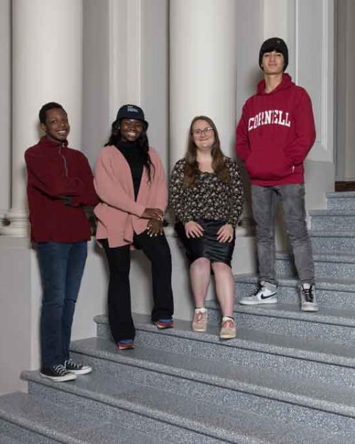 		four students on stairs 
	
