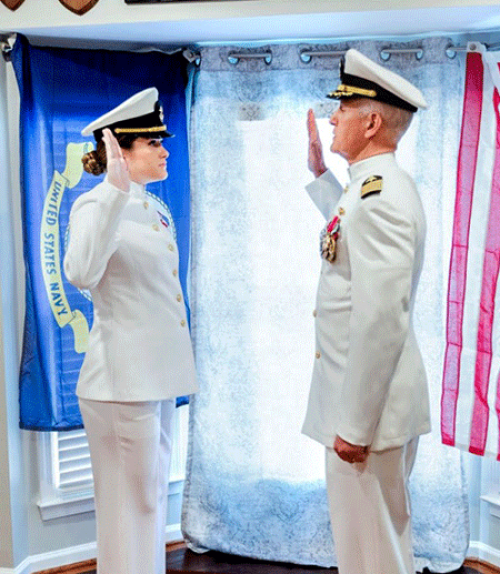 		 Two people in military uniform, facing each other
	