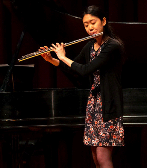 		 Joy Zhang playing the flute
	