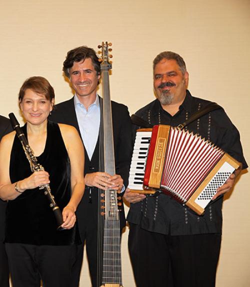  Three of the musicians from Big Galute holding their instruments