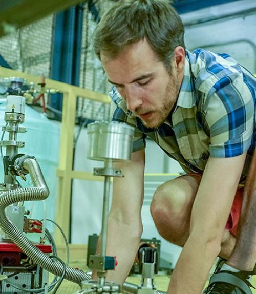  Brad Ramshaw kneeling by the magnet used in the experiment