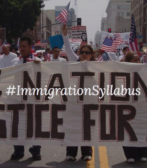 		 Protesters holding banner saying &amp;quot;Immigration Syllabus&amp;quot;
	