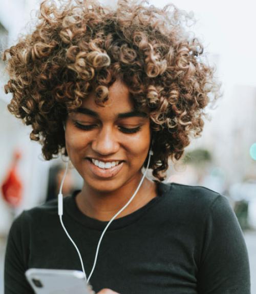 		 Woman listening to music on her iphone
	