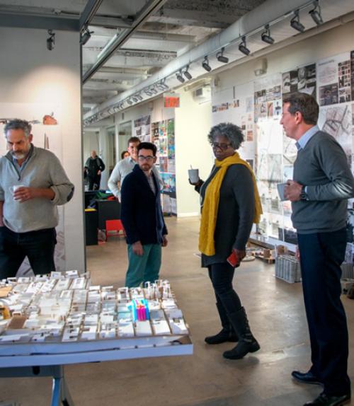  Faculty gathered around exhibition table