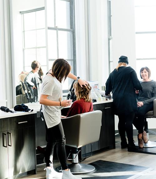  Hairdresser working on a client in a bright room