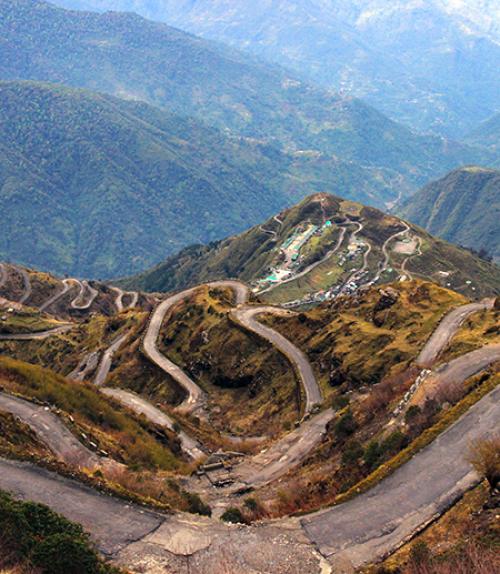 		 Winding road through mountains, seen from above
	