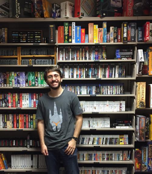 		 Student in front of shelf full of video games
	