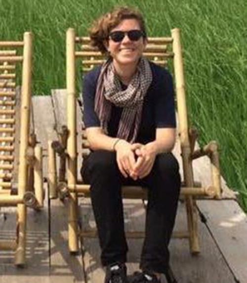 		 Person wearing sunglasses, sitting in chair
	