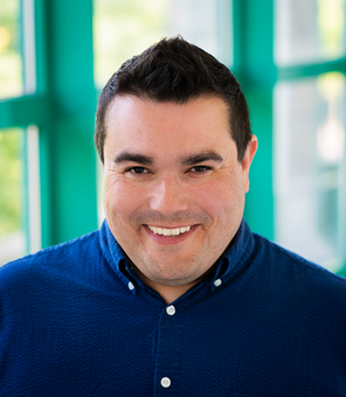  Jeff Palmer headshot in a blue shirt before a window.