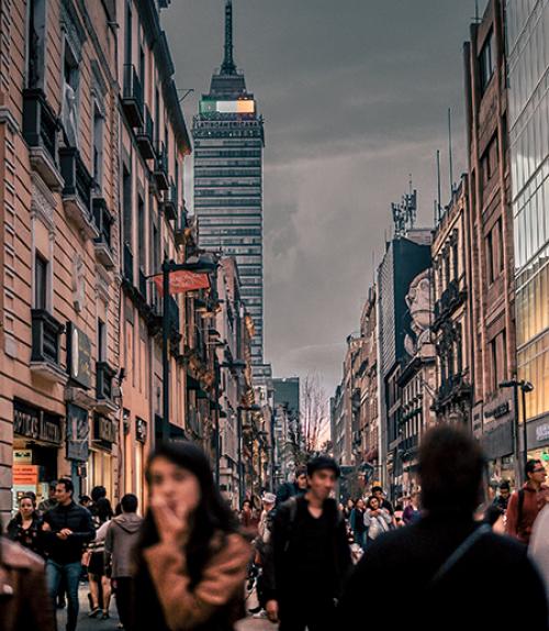 		 City street full of people; dark sky
	