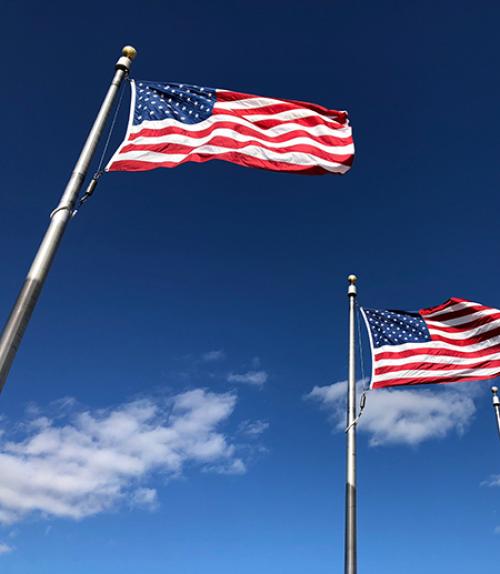 		 Two American flags on poles
	