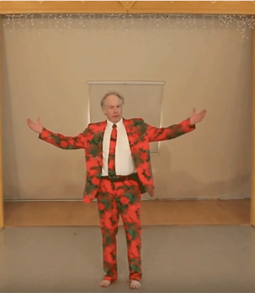		 Man wearing a red suit, arms raised
	