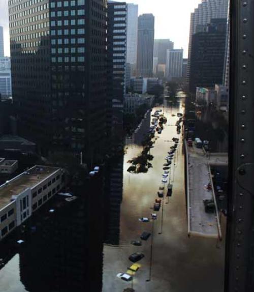 		 Tall buildings overlook a flooded street in New Orleans
	