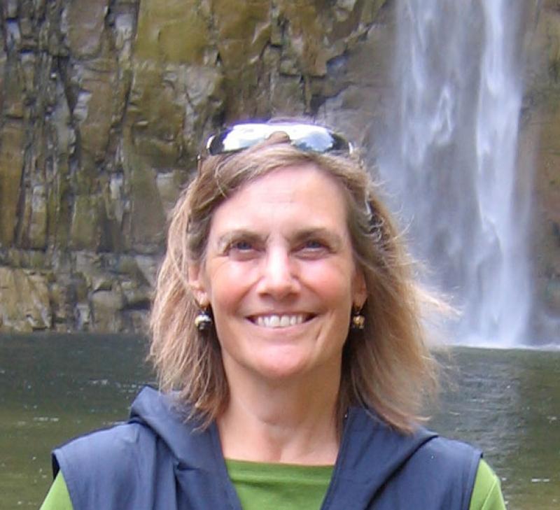 Nancy Green in front of a waterfall.