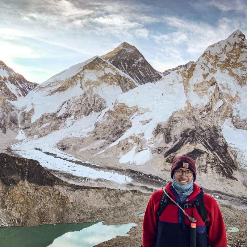 man in mountains with lake
