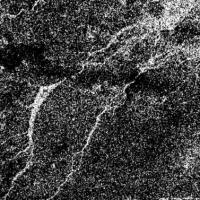 		A black and white aerial image of Titan's river system.
	