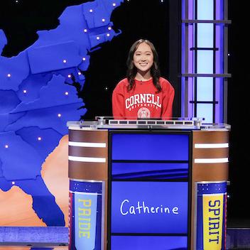 Three people on a game show set