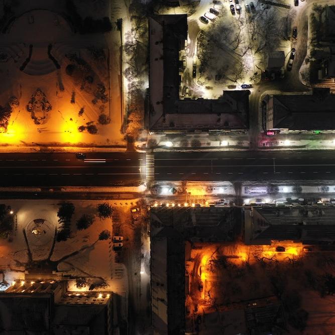 City blocks lit up at night, seen from far above