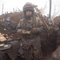 		Solder wearing battle-worn clothing, eating out of a cup
	
