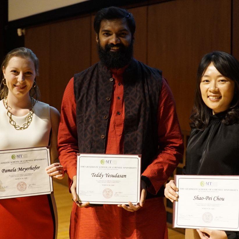 Three people hold certificates