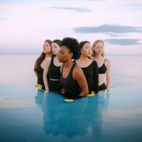 		five women standing in water
	