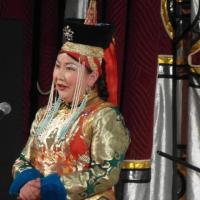 Person singing in a brightly colored traditional costume of Mongolia