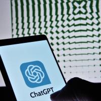 		Small screen shows ChatGPT/OpenAI logo with a large screen showing a pattern in the background
	