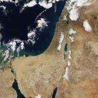 		Satellite of the middle east region, seen from space: brown land, dark blue sea, highlights of snow, unusual for the region
	