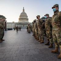 Line of soldiers in fatigues; US Capitol in background
