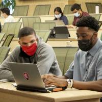 students working together on a computer