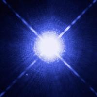 Four lines of light radiating out from a white dwarf star on a blue background.