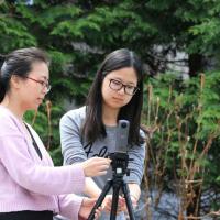 two students with video camera