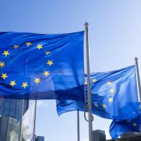 Three blue flags on poles