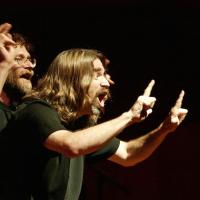 Two people performing with dramatic hand gestures and facial expressions