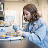 woman with test tubes and pipette