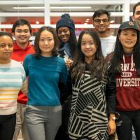 Eight students face forward