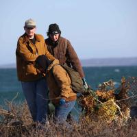 two people dragging lobster traps