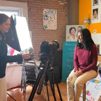 person being filmed and three other people with cameras and audio recording devices