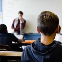 Students in a classroom, seen from behind