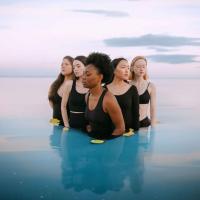 five women standing in water
