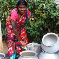  Woman in India cleaning out her water containers