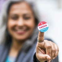  Voting sticker help up by a smiling person