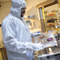  A man wearing protective gear in a lab