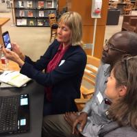 Faculty learning how to use a smartphone to share infrmation