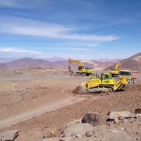  Bulldozers at the site of the telescope, with mountains in the background